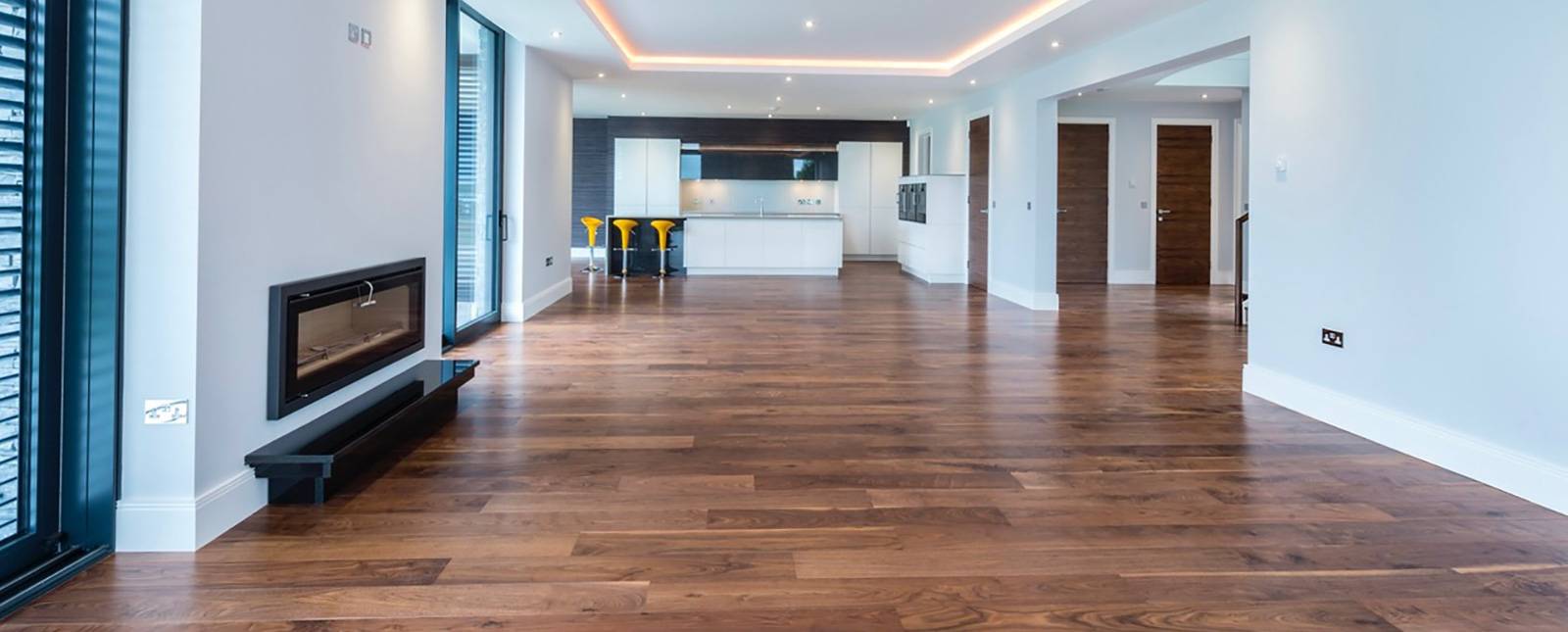 Wide-plank walnut flooring in open-plan kitchen