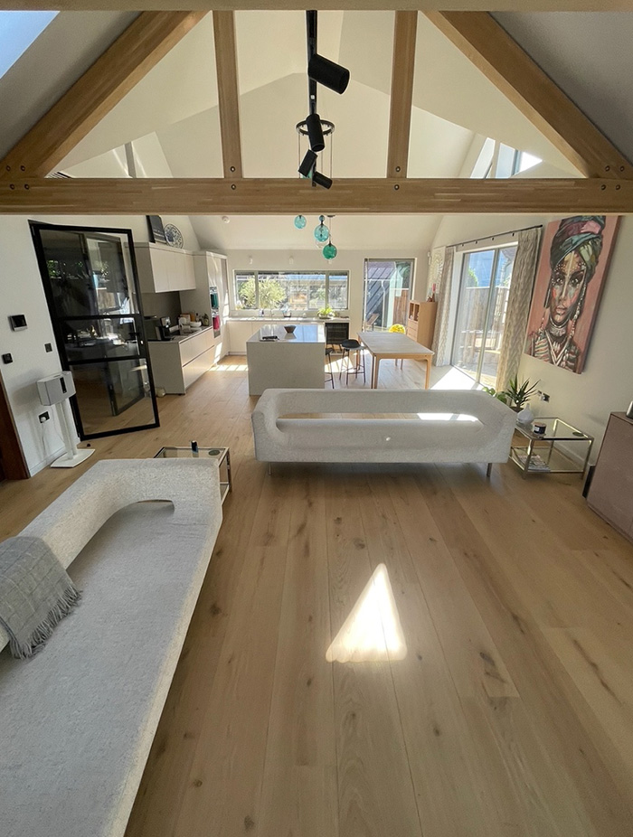 Open-plan vaulted living space with engineered oak floor